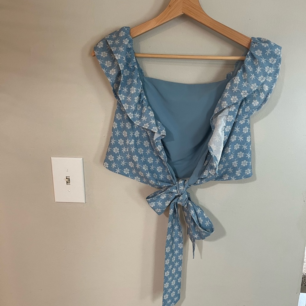 Cute crop top with ruffled shoulders and low back bow tie